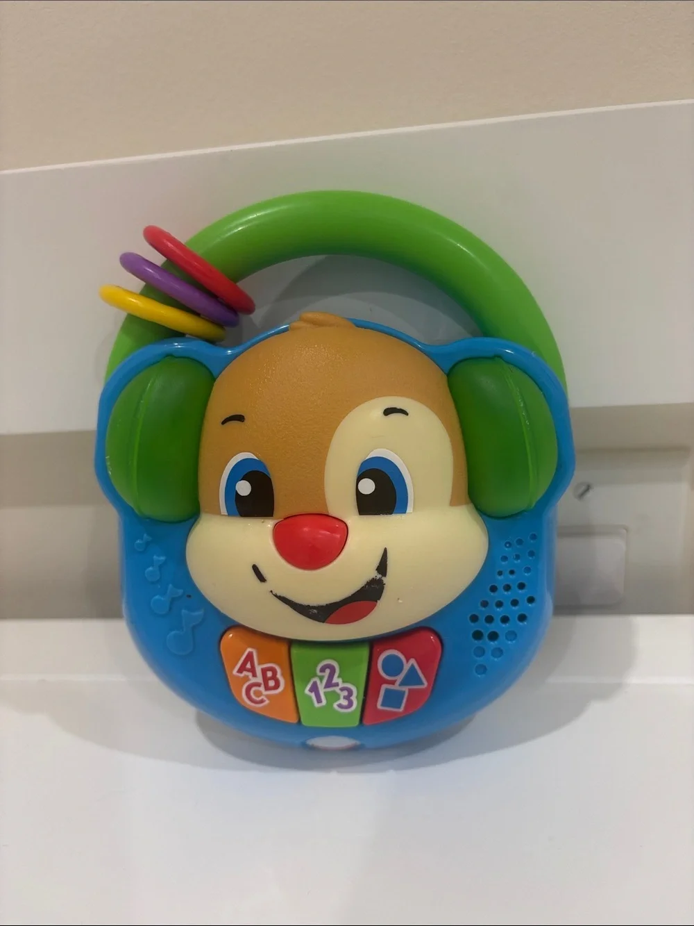 Fisher-Price Blue Puppy Learning Toy with Green Handle and Multicolor Rings